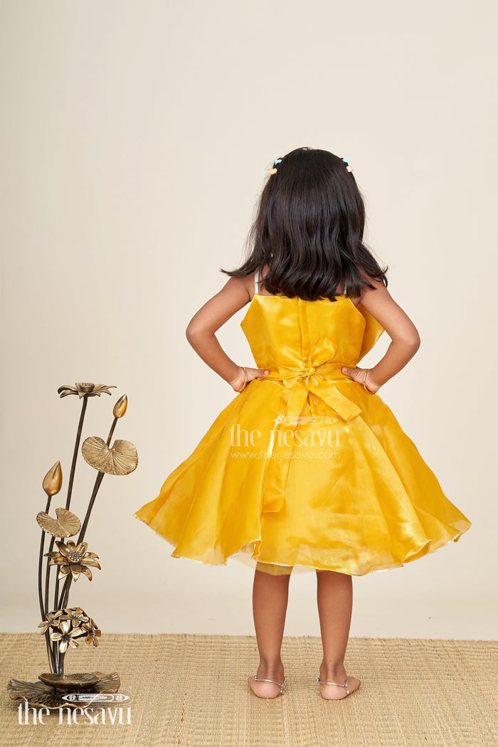 The Nesavu Girls Fancy Party Frock Girls golden satin party frock with bow detail Nesavu Nesavu girls golden satin party frock with bow and silver trim festive and elegant