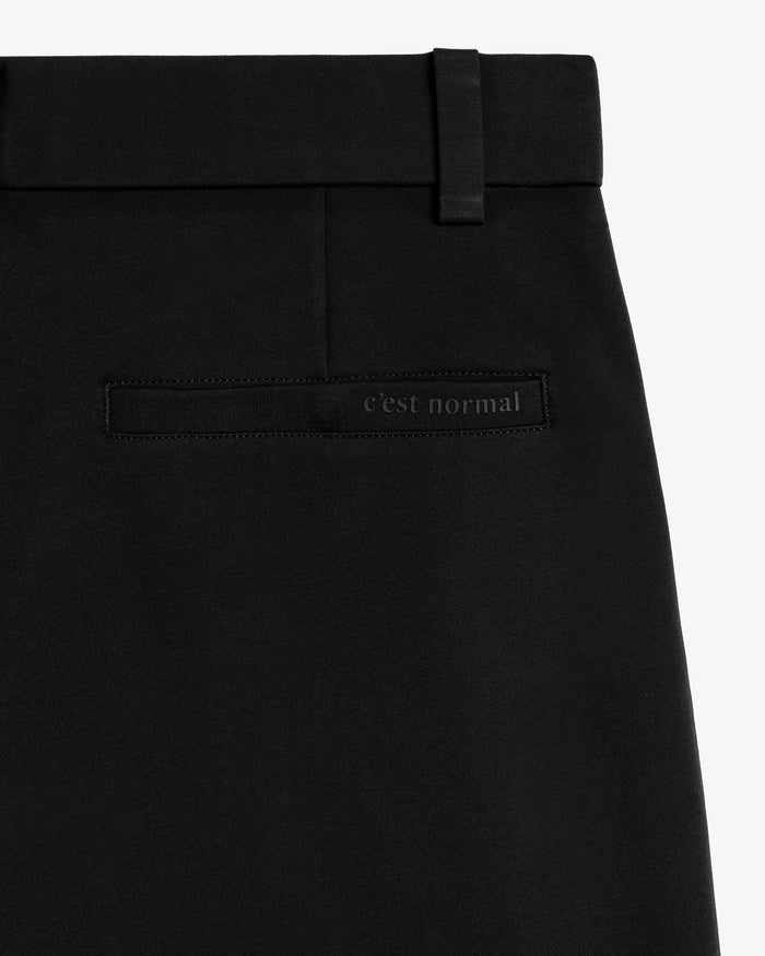 The Proper Pant Classic Straight Fit in black — back pocket with C'est normal logo