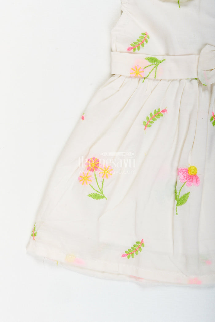 The Nesavu Baby Cotton Frocks White frock for baby girls with floral embroidery and waist bow Nesavu Nesavu white cotton frock for baby girls with bow and floral embroidery for casual dressing