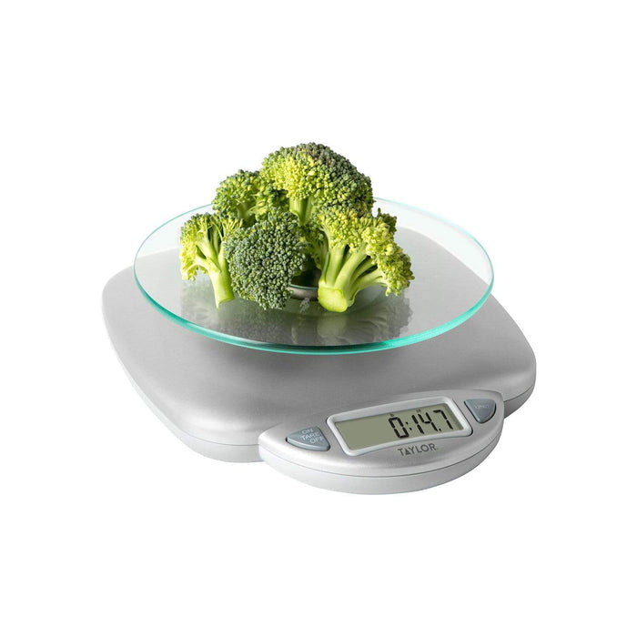 Close up of the 11 lb digital glass top kitchen scale with broccoli on the glass plate