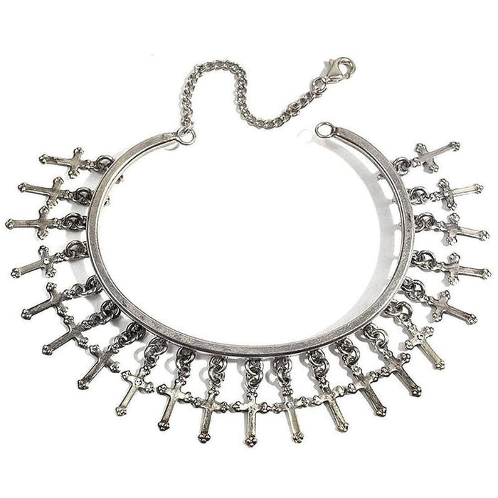 Silver cuff bracelet adorned with dangling cross charms.