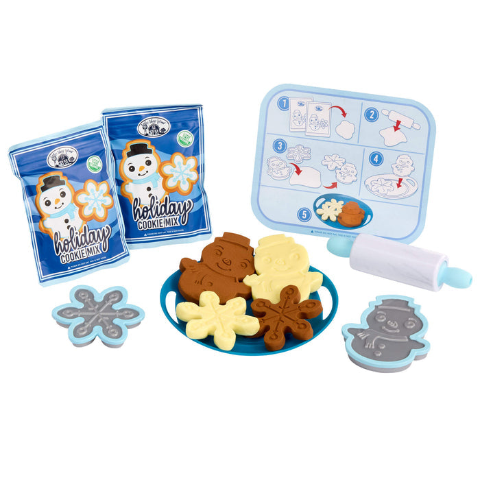 Holiday cookie mix set with cookie cutters and mixing instructions on a white background