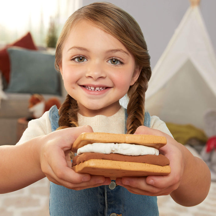 Child holding a s'mores cookie stack