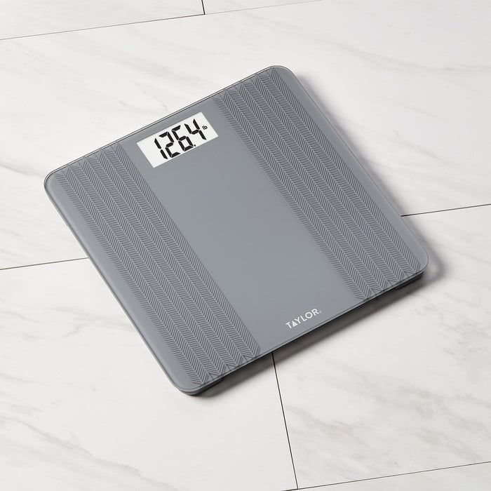 Angled view of gray digital scale with herringbone texture and Taylor branding.
