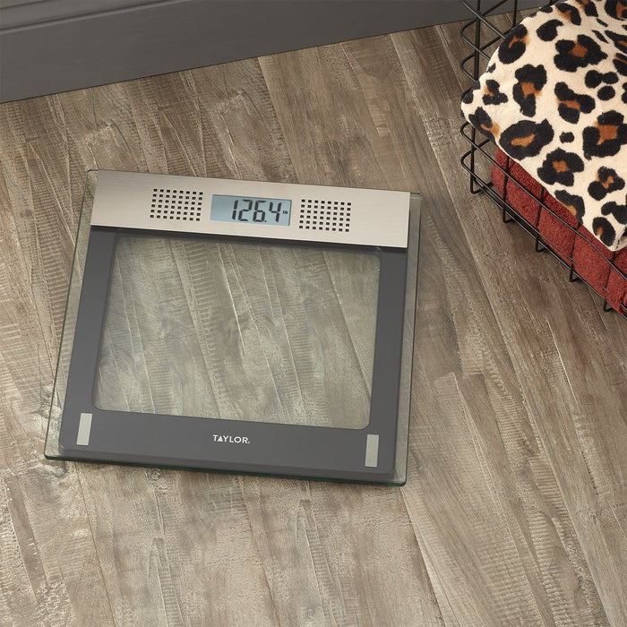 Taylor digital talking bathroom scale with clear glass top and gray frame showing 126.4 lb