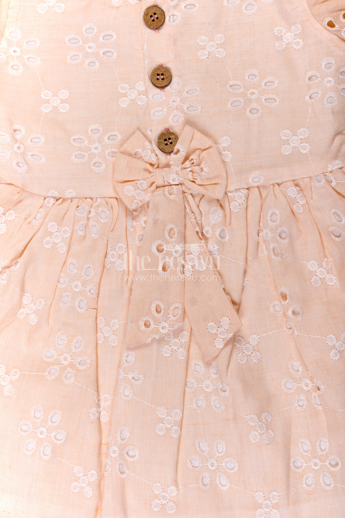 The Nesavu Girls Cotton Frock Girls Cotton Sleeveless Dress in Pastel Peach with All-Over Hakoba Floral Embroidery Nesavu Nesavu Cotton Sleeveless Dress for Girls in Peach Hakoba Fabric with Embroidery and Button Detail