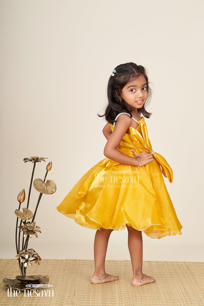 The Nesavu Girls Fancy Party Frock Girls golden satin party frock with bow detail Nesavu Nesavu girls golden satin party frock with bow and silver trim festive and elegant