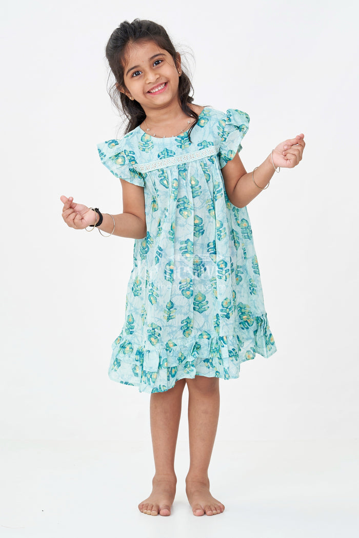 The Nesavu Girls Fancy Frock Girls Sky Blue Frock Design in Rayon with Leaf Motifs and Ruffle Accents for Whimsical Wear Nesavu 18 (2Y) / Blue GFC1761B-18 Nesavu Girls Sky Blue Frock Design Rayon Green Leaf Digital Print Ruffle Hem