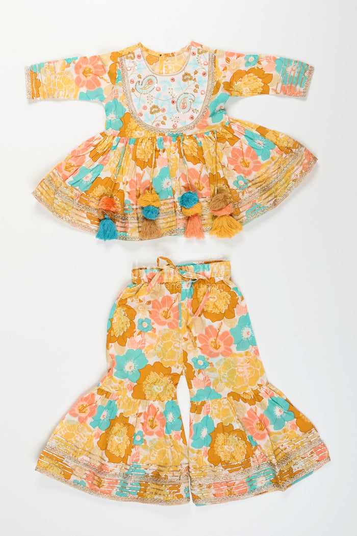 The Nesavu Girls yellow cotton sharara set with tassels and floral block print for ethnic days Nesavu Nesavu girls yellow cotton block print sharara set tassels  ethnic outfit school casual celebrations
