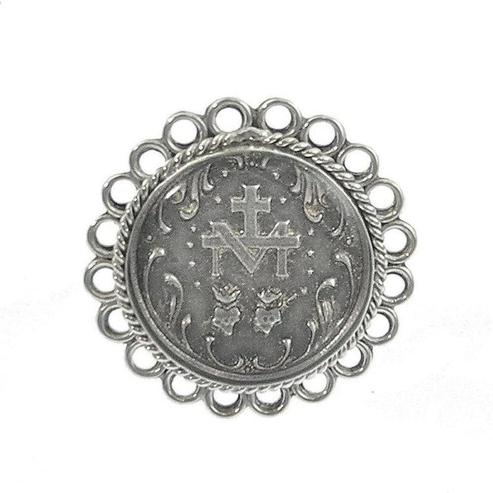 Silver ring featuring an ornate circular design, centered with a religious medallion.