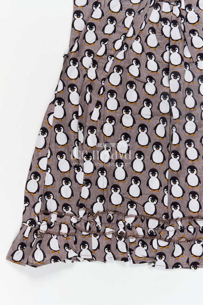 The Nesavu Girls Cotton Frock Kids Casual Cotton Printed Frock for Girls with Brown Penguin Block Print and Frilled Shoulders Nesavu Nesavu Brown Hand Block Kids Casual Cotton Printed Frock Penguin Motifs Ruffled Design