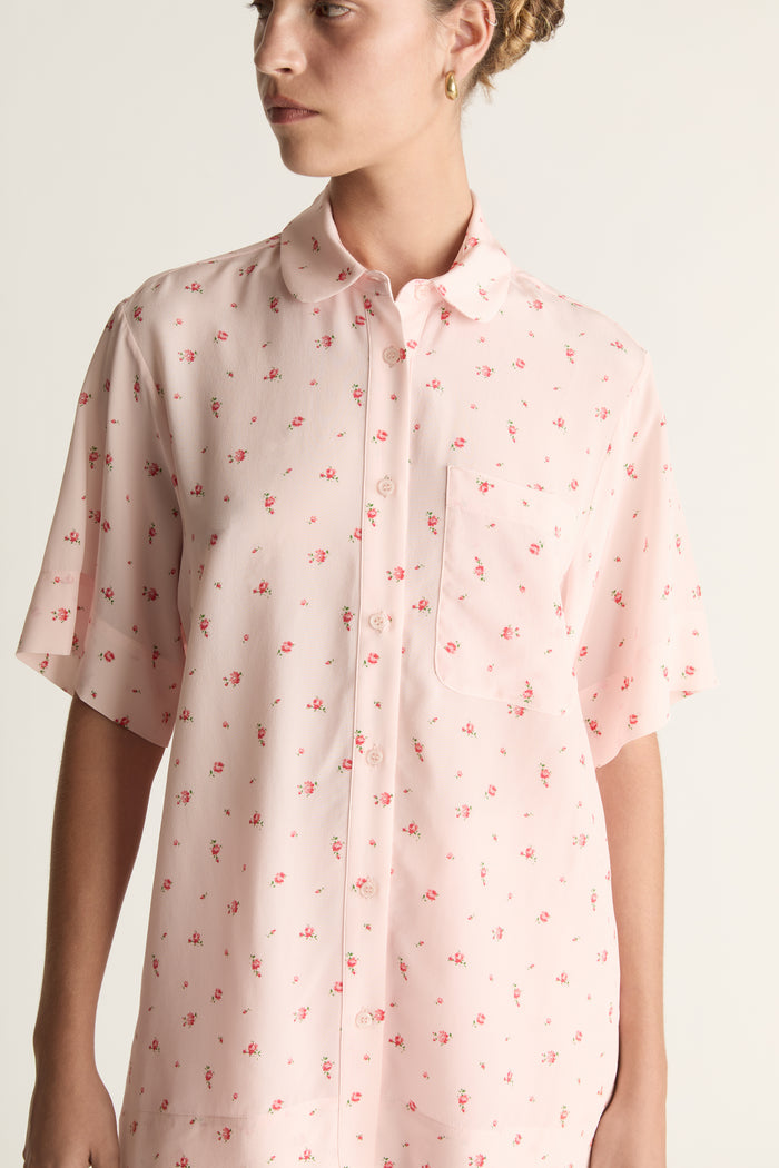 Person wearing pink floral short sleeve shirt and pants set