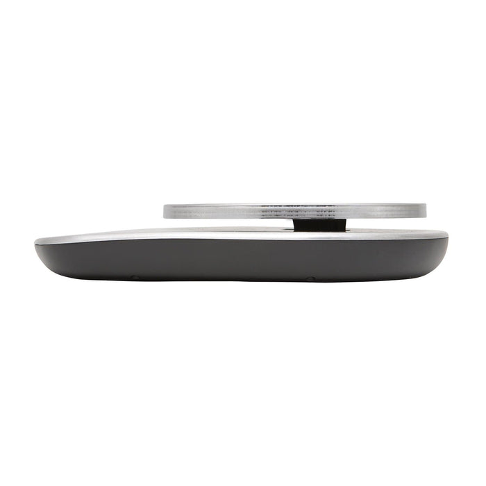 Side view of a low profile stainless steel kitchen scale with a slim silver weighing plate.