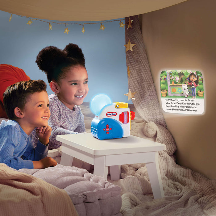 Two children sitting in a cozy room with a Little Tikes toy and a nightlight.