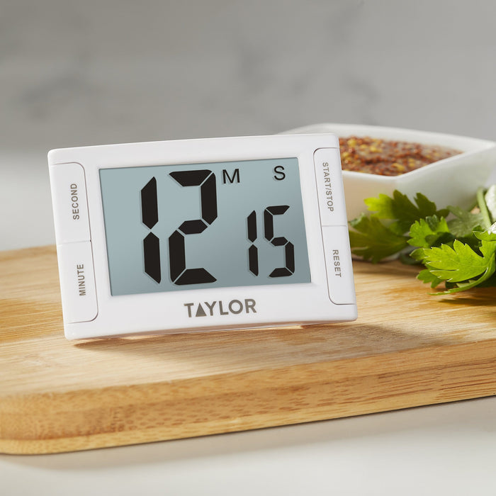 Side view of a Taylor Super Readout Timer against a gray backdrop with a blurred dish in the background