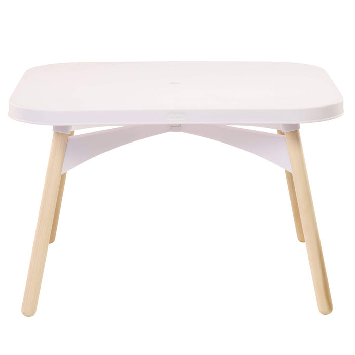 A modern low table with a rounded white top, a white curved support structure underneath, and four light natural wood legs, shown against a solid white background.