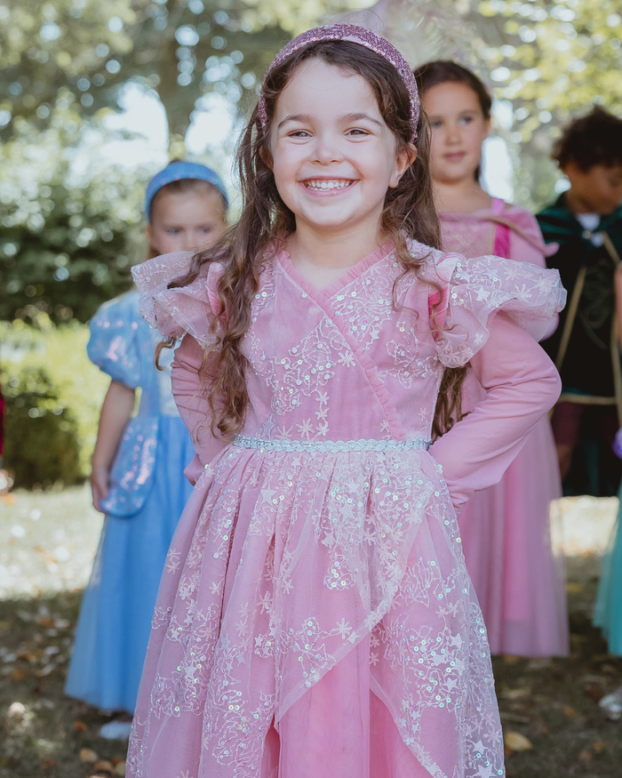 Girl wearing a star-embroidered tulle party dress with statement shoulders