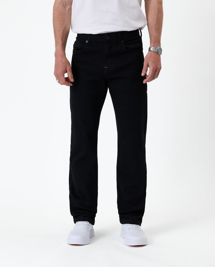 The Jeans Classic Straight Fit in Jet Black — front view worn with white sneakers