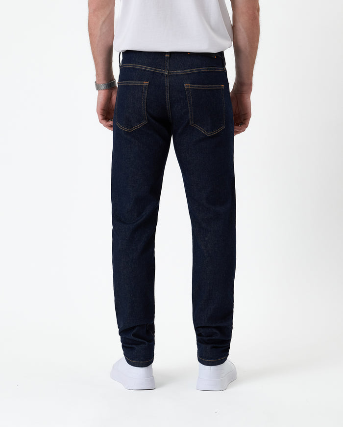The Jeans Slim Fit in Rinse Wash — back view showing the clean slim silhouette