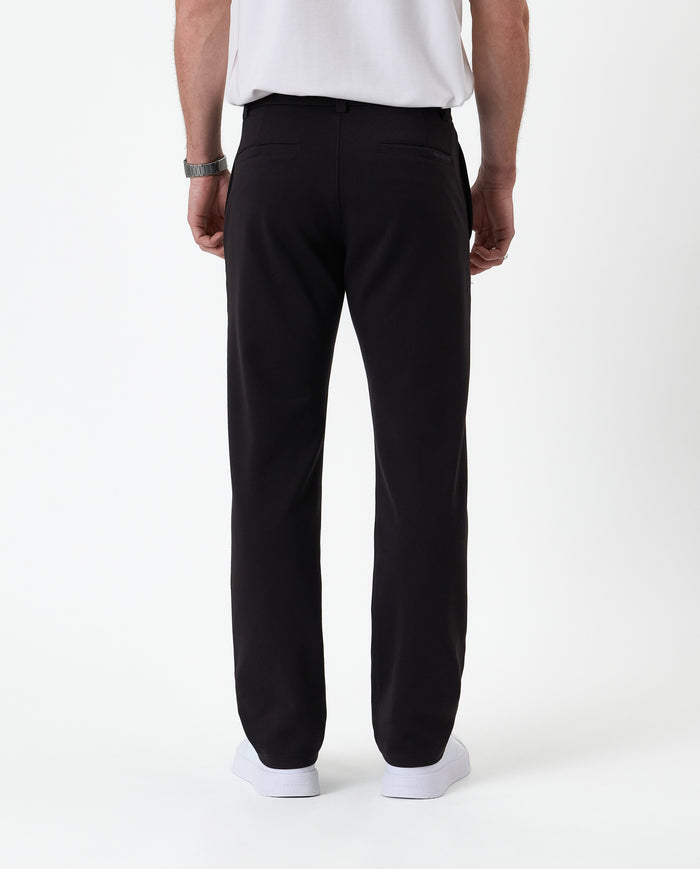 The Proper Pant Regular Fit in black — back view showing the rear welt pockets