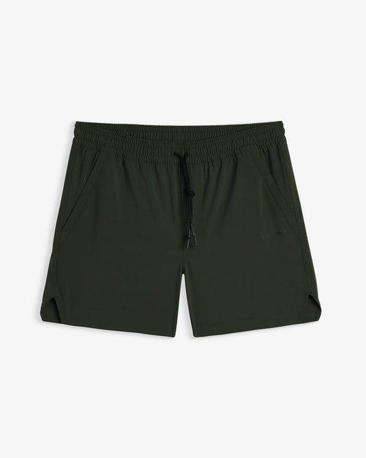 A front view of The Shorts in khaki, laid flat on a white background. The image highlights the elasticated waistband with a black drawstring, side pockets, notched hem, and a subtle c'est normal logo on the left leg.