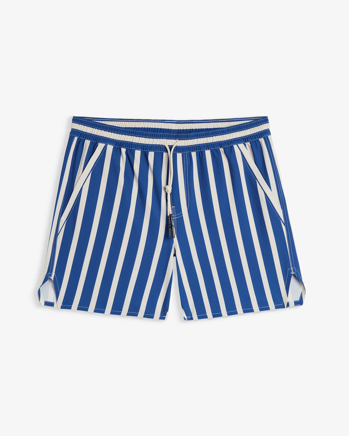 A front view of The Shorts in a nautical stripe pattern, laid flat on a white background. The image highlights the blue and white vertical stripes, elasticated waistband with a drawstring, two side pockets, and notched hems.