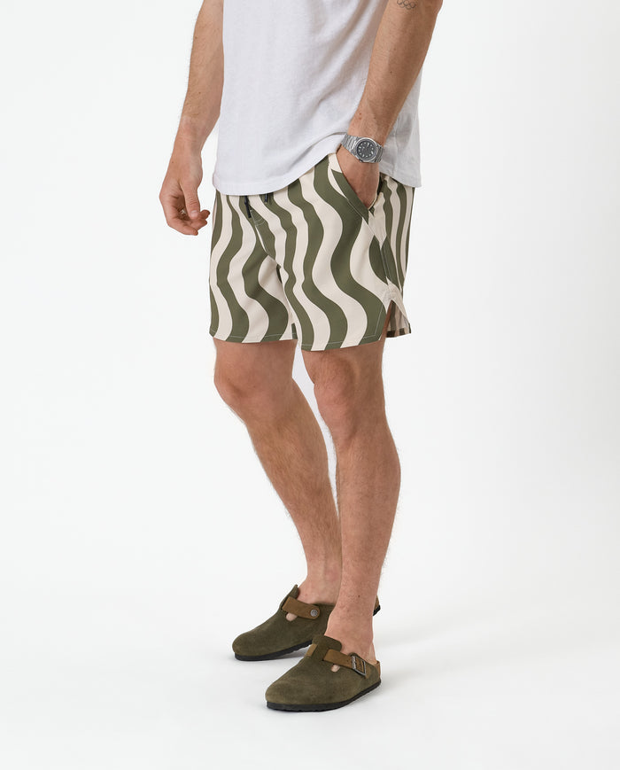 The Shorts in olive curl stripe — worn with olive clogs and a white t-shirt