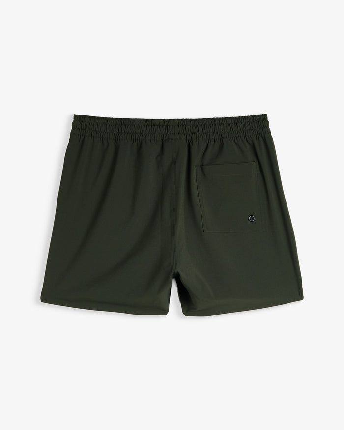 A back view of The Shorts in khaki, laid flat on a white background. The image highlights the elasticated waistband and the back pocket with a drainage eyelet from c'est normal.