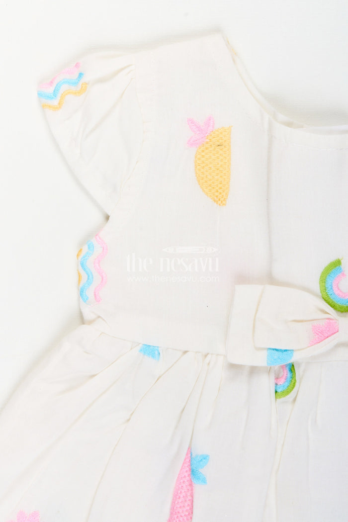 The Nesavu Baby Cotton Frocks White baby girl frock with pastel embroidery for everyday wear Nesavu Nesavu white baby girl frock with pastel rainbow embroidery and flutter sleeves for casual wear