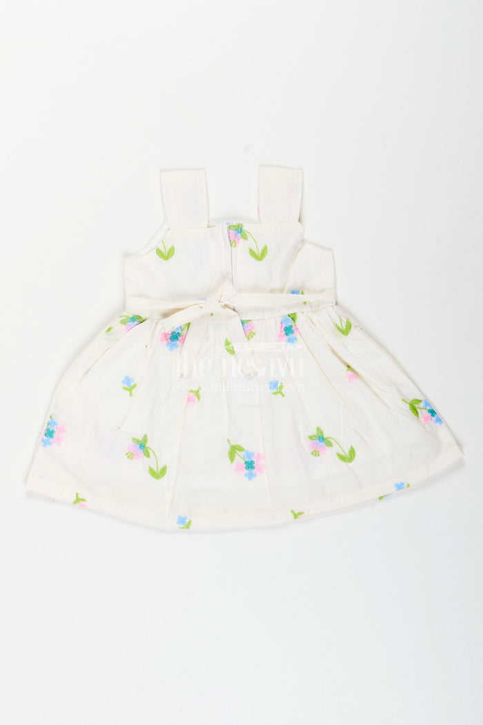 The Nesavu Baby Cotton Frocks White cotton frock with floral embroidery and shoulder straps for baby girls Nesavu Nesavu white cotton frock for baby girls with shoulder straps and colorful floral embroidery