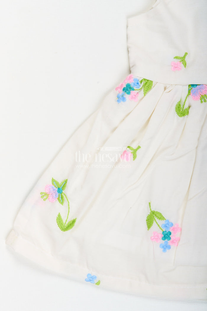 The Nesavu Baby Cotton Frocks White cotton frock with floral embroidery and shoulder straps for baby girls Nesavu Nesavu white cotton frock for baby girls with shoulder straps and colorful floral embroidery